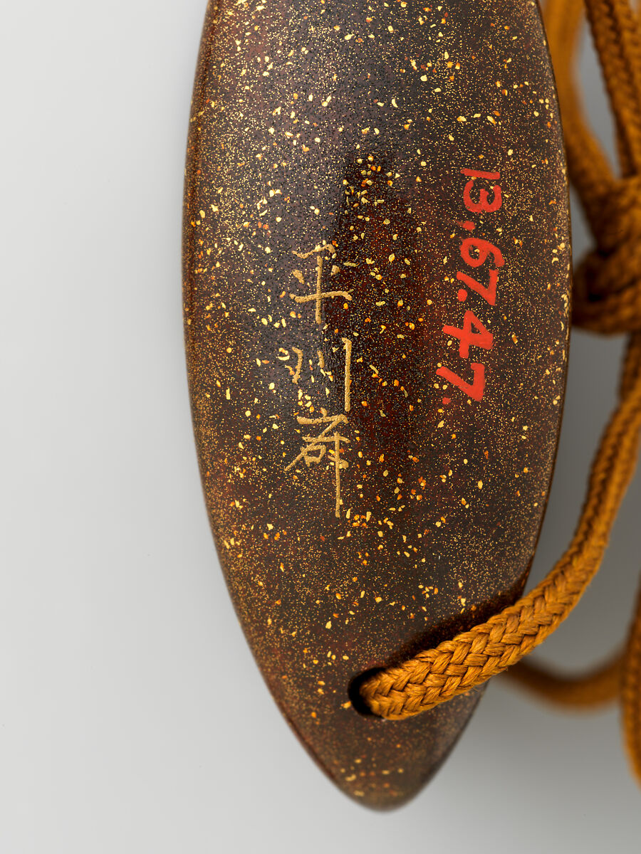 Inrō with floating fans, Lacquered wood with gold and silver togidashimaki-e and hiramaki-e 
 Ojime: lacquer bead with maki-e decoration 
 Netsuke: ivory toggle of Shōki, the Demon Queller, Japan