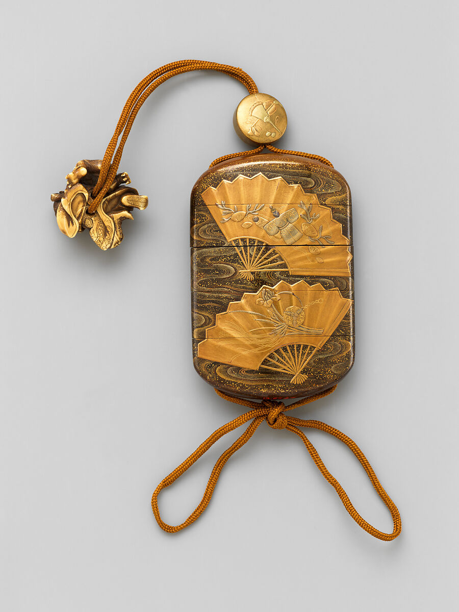 Inrō with floating fans, Lacquered wood with gold and silver togidashimaki-e and hiramaki-e 
 Ojime: lacquer bead with maki-e decoration 
 Netsuke: ivory toggle of Shōki, the Demon Queller, Japan