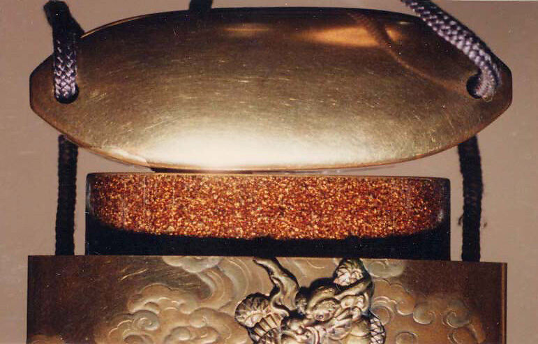 Case (Inrō) with Design of Magician Handaka Sonja Seated beneath Tree (obverse); Karako Pointing at Dragon in Sky (reverse), Lacquer, kinji, gold, silver, brown and red hiramakie, metal inlay; Interior: nashiji and fundame, Japan