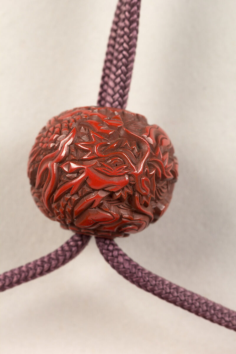 Inrō with the Noh Play Ebira (Quiver), Three cases; lacquered wood with gold, silver, color takamaki-e, hiramaki-e on red ground
Netsuke: fossilized wood
Ojime: carved red lacquer bead, Japan