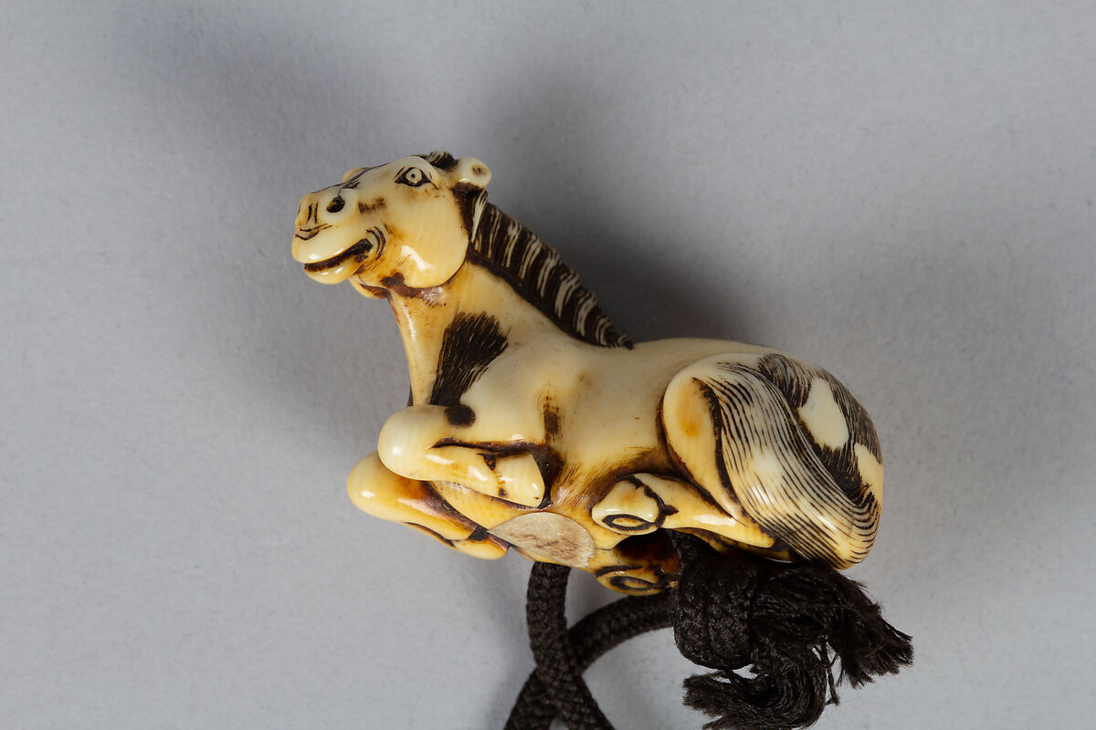 Inrō with Two Standing Horses; Seal and Inscription (reverse), After Kano Naonobu (Japanese, 1607–1650), Four cases; lacquered wood with gold hiramaki-e, gold foil application, and mother-of-pearl inlay on black groundNetsuke: horse; ivory Ojime: iron bead with cricket and flower in gold overlay, Japan