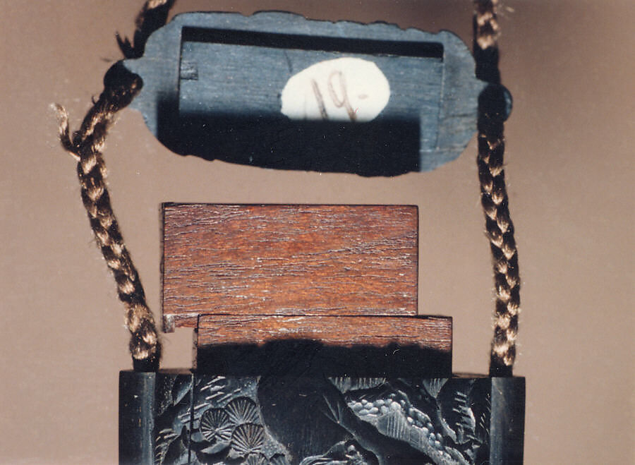 Case (Inrō) with Design of Fukurokuju (God of Longevity) Riding a  Flying Crane before Waterfall (obverse); Kinko Sennin Riding a Carp on Waves (reverse), Wood, ebony, carved relief; Interior: plain, boxes, Japan