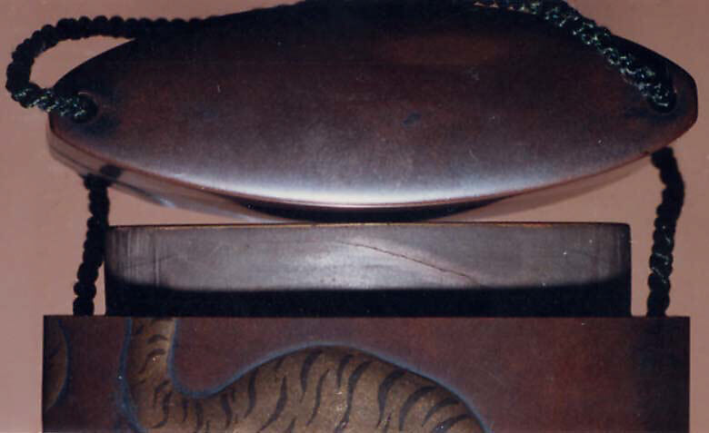 Case (Inrō) with Design of Tiger Seen from Behind, Lacquer, shibuichi coloured ground, gold, silver and red hiramakie, inlaid eye; Interior: red lacquer & silver fundame, Japan