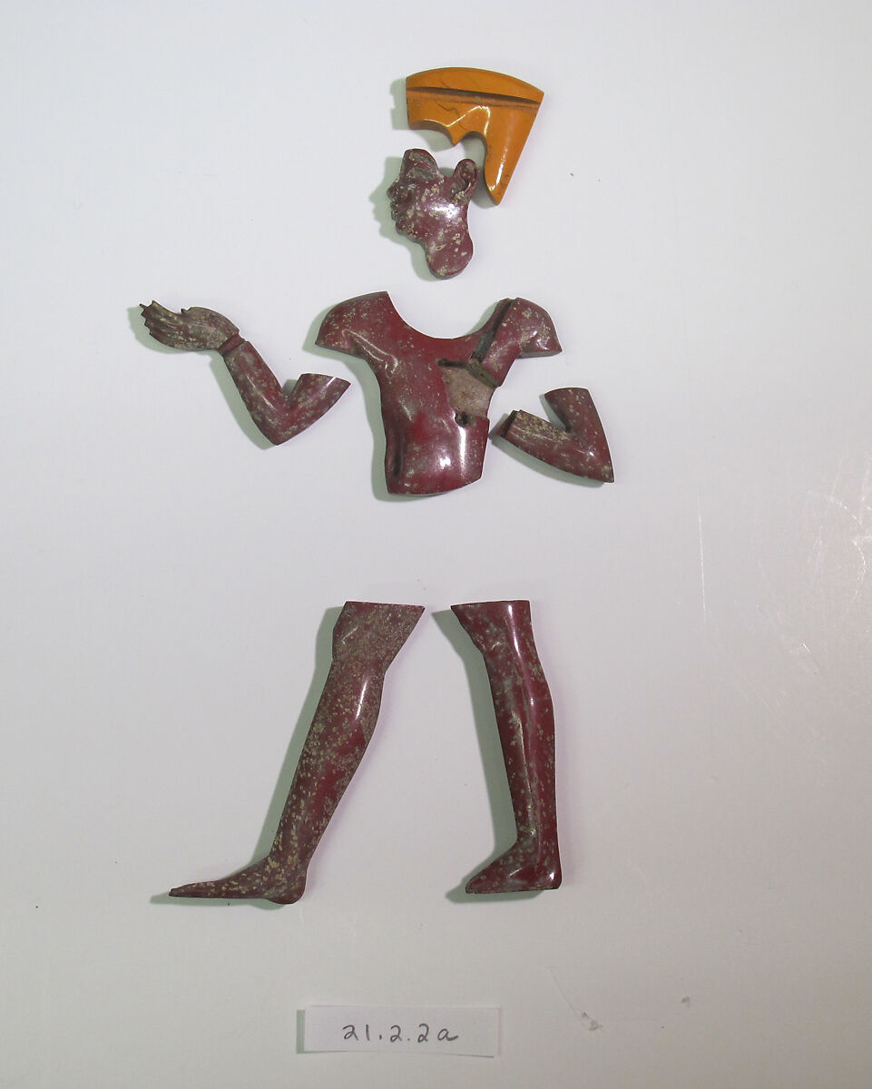 Inlays from shrine: male figure in yellow headdress, with sidelock: crown, head, torso, arm, pair of legs, Glass 