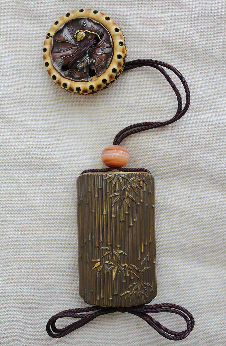 Saya Inrō with Pine and Ivy (obverse) and Bamboo Grove (reverse), Sheath shape; lacquered wood with gold and silver takamaki-e, hiramaki-e, togidashimaki-e, and colored ivory inlay on gold lacquer ground Netsuke: kagamibuta type, lotus pad with frog; stained ivory and metal, Japan 