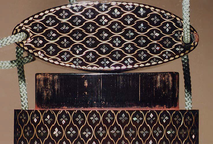 Inrō with Geometric Pattern, Four cases; lacquered wood with metal and mother-of-pearl inlay on black lacquer ground; Netsuke: ryūsa type carved ivory; floral design; Ojime: metal bead with chrysanthemum, Japan