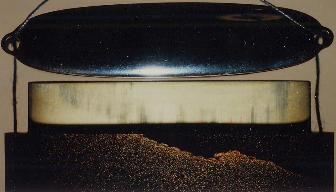 Case (Inrō) with Design of Flying Cuckoo in Flight above Pines (obverse); Bonito (Fish) on Bamboo Leaves (reverse), Toyōsai (1772–1845), Black lacquer with sprinkled gold and silver makie and mother-of-pearl
Ojime: bead with openwork design of waves; silver
Netsuke: fish laid on bamboo branch; stained ivory, Japan