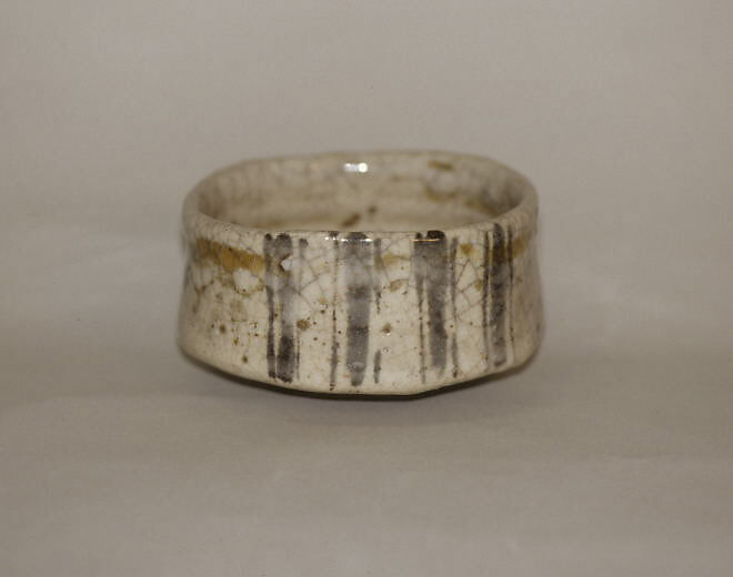 Tea bowl decorated with chrysanthemums and wavy lines, Clay, pitted; thick, whitish crackled glaze; decoration in blue (Mino ware, Shino type), Japan