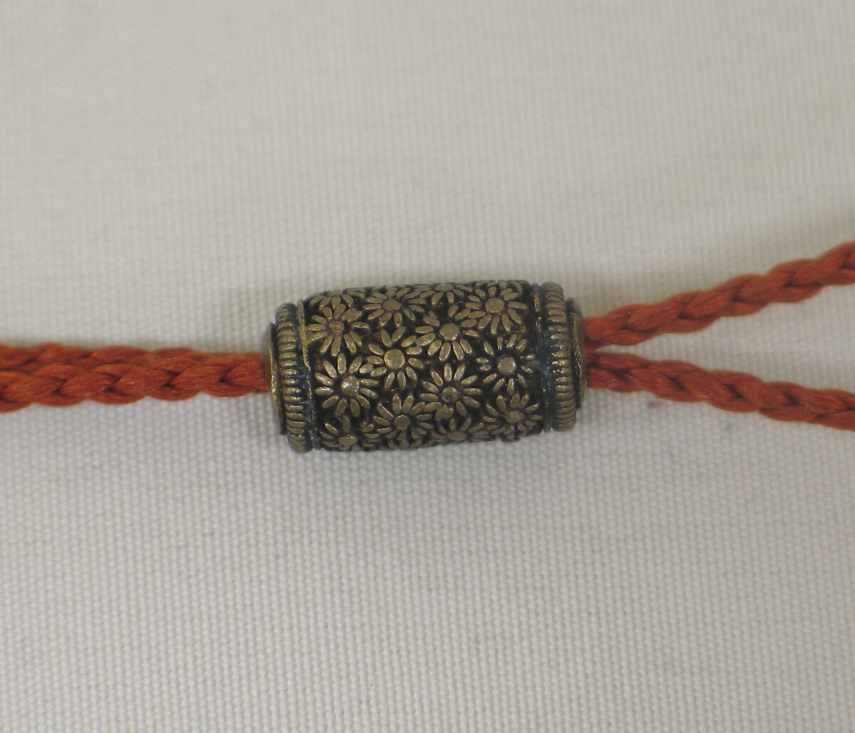 Inrō with Birds, Plum, Chrysanthemum, and Loquat, Gold lacquer ground with mother-of-pearl, coral, and stained ivory inlay in Shibayama style
Netsuke: thunder god playing samisen; carved ivory
Ojime: cylinder with asters in openwork, Japan