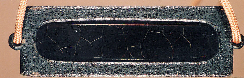 Inrō Imitating an Old Chinese Ink Cake, Ogawa Haritsu (Ritsuō) (Japanese, 1663–1747), Two-part (sheath-type); lacquered wood, metal, leather, with black and brown togidashimaki-e, takamaki-e on black groundNetsuke: manjū type with maki-e DarumaOjime: ceramic bead with incense and ash design , Japan