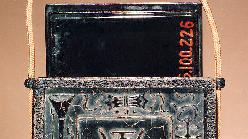 Inrō Imitating an Old Chinese Ink Cake, Ogawa Haritsu (Ritsuō) (Japanese, 1663–1747), Two-part (sheath-type); lacquered wood, metal, leather, with black and brown togidashimaki-e, takamaki-e on black groundNetsuke: manjū type with maki-e DarumaOjime: ceramic bead with incense and ash design , Japan
