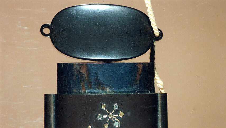 Case (Inrō) with Symbols of Girls' Festival (obverse); Emblems for New Year Festival (reverse), Metal, dark silver metal ground, applied silver and gold metals; Interior: black lacquer and silver metal, Japan