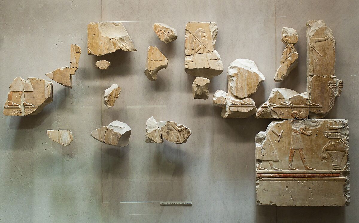 Relief scene from the tomb of Queen Neferu: fragments from two registers showing male and female attendants moving to the right, Limestone, paint