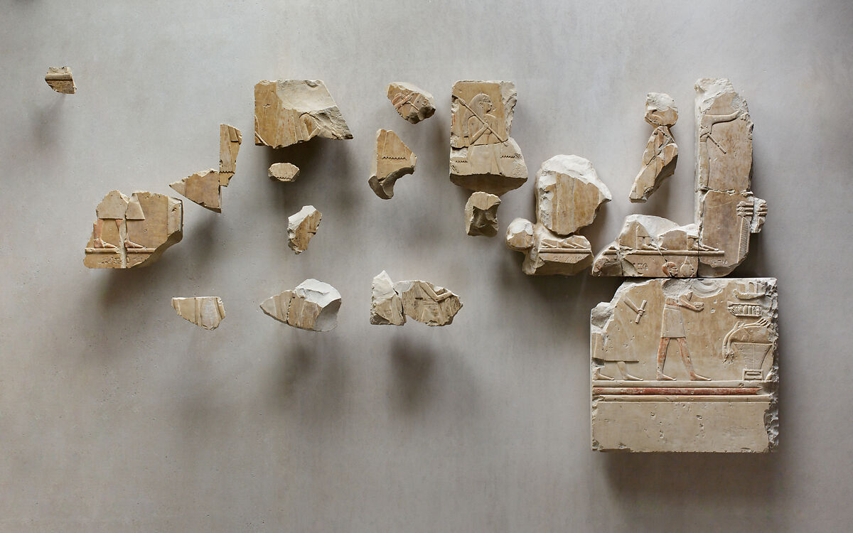 Relief scene from the tomb of Queen Neferu: fragments from two registers showing male and female attendants moving to the right, Limestone, paint 