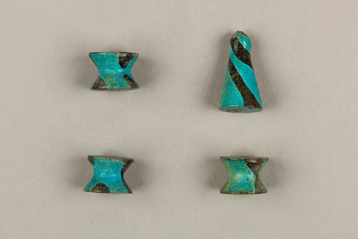 Seven Spool-Shaped Gaming Pieces, Faience 