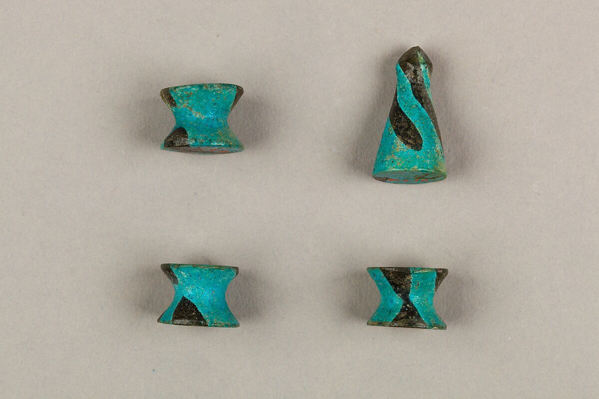 Seven Spool-Shaped Gaming Pieces, Faience