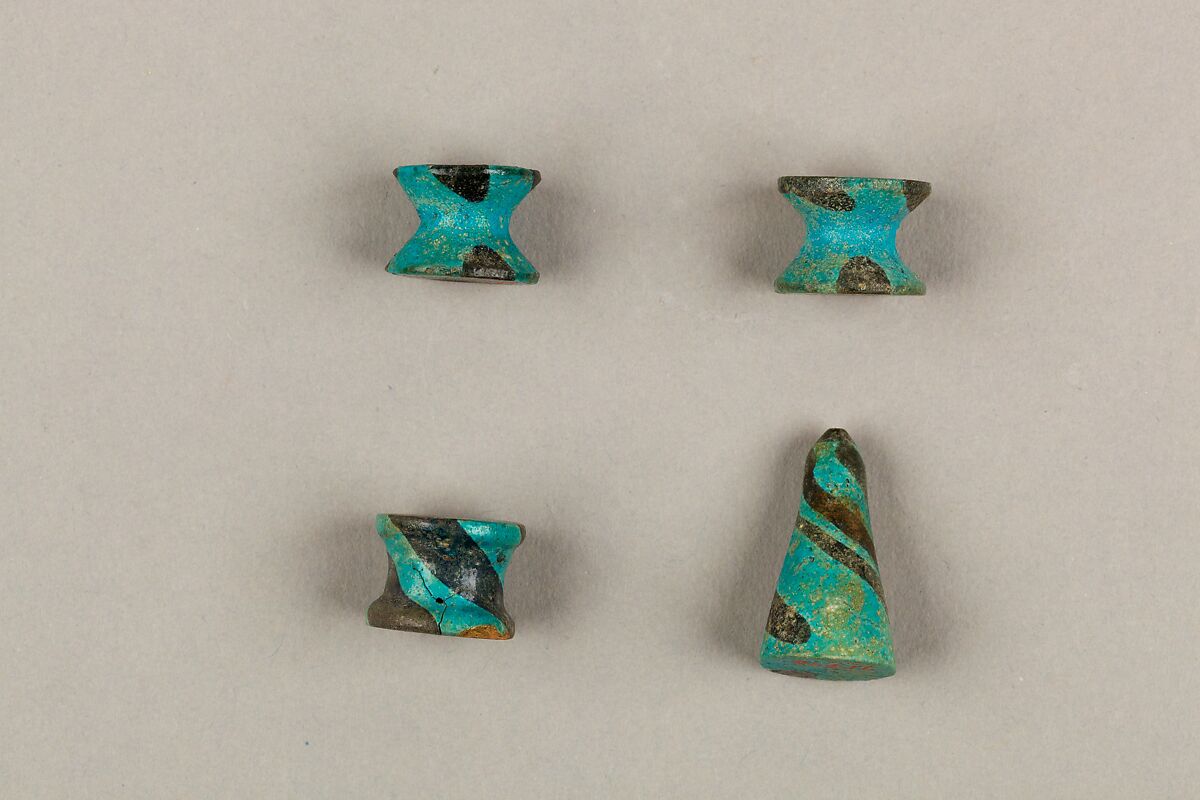 Seven Spool-Shaped Gaming Pieces, Faience