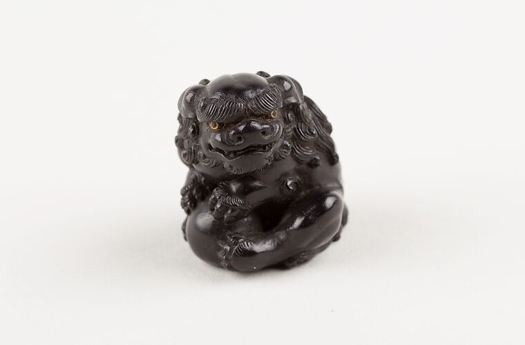 Netsuke of Seated Shishi Clutching a Ball