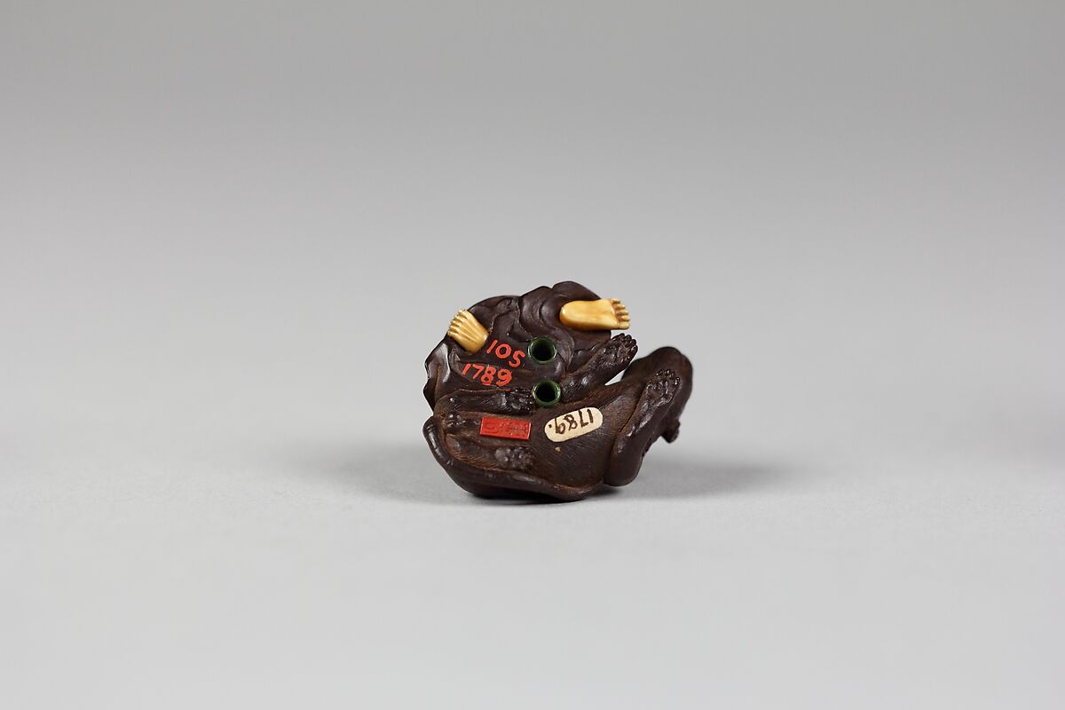 Netsuke of Old Man with a Tiger, Wood and ivory, Japan