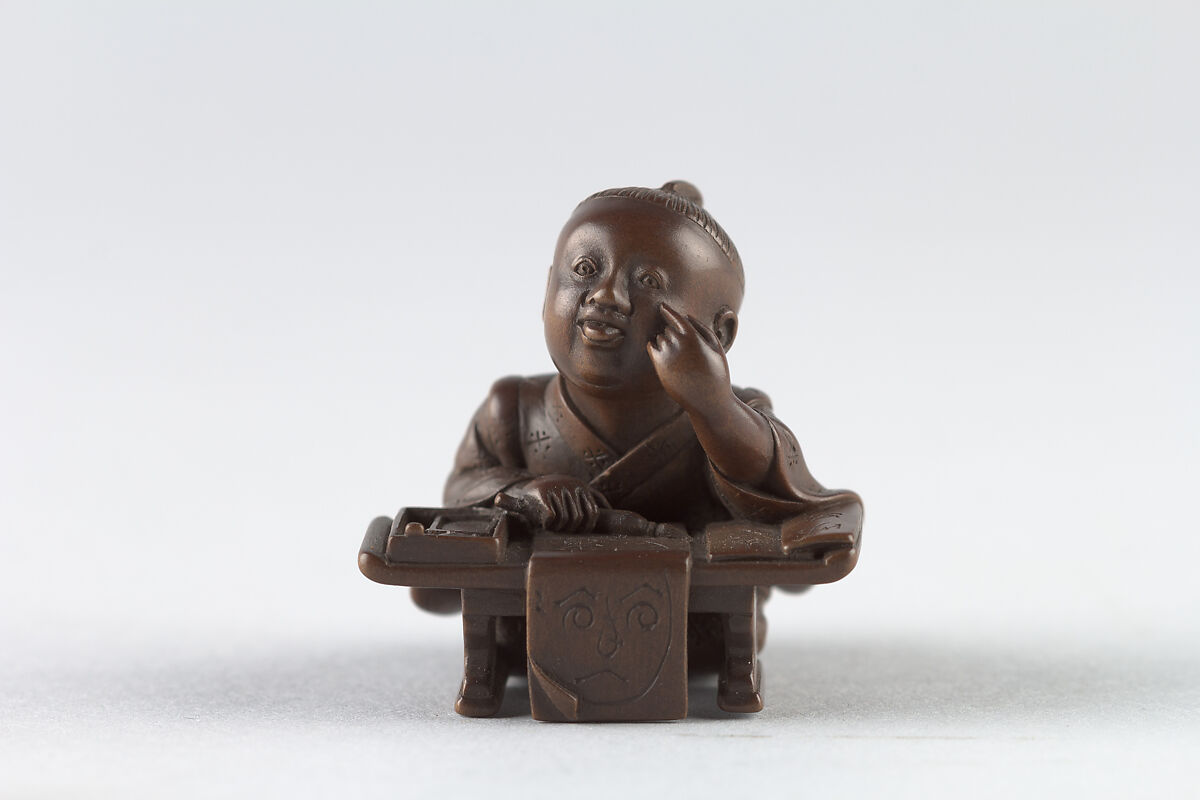 Netsuke of Young Boy at Writing Desk, Dreaming, Wood, Japan 