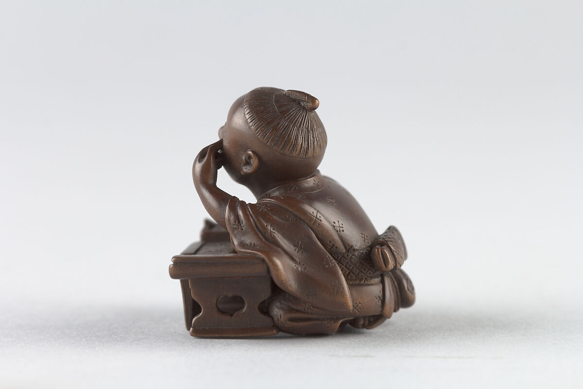 Netsuke of Young Boy at Writing Desk, Dreaming, Wood, Japan