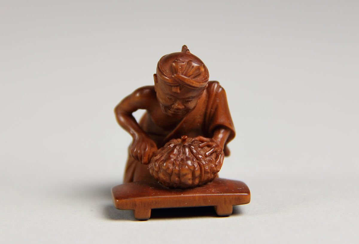 Netsuke of Man Cutting Pumpkin, Wood, Japan 