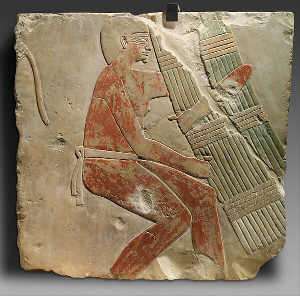 Relief of a Man Carrying a Papyrus Bundle, Limestone, paint 