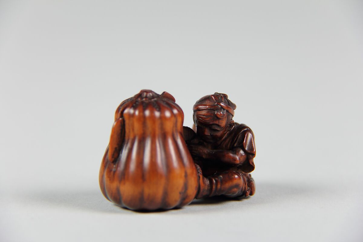 Netsuke of Boy Cutting a Gourd, Wood, Japan 