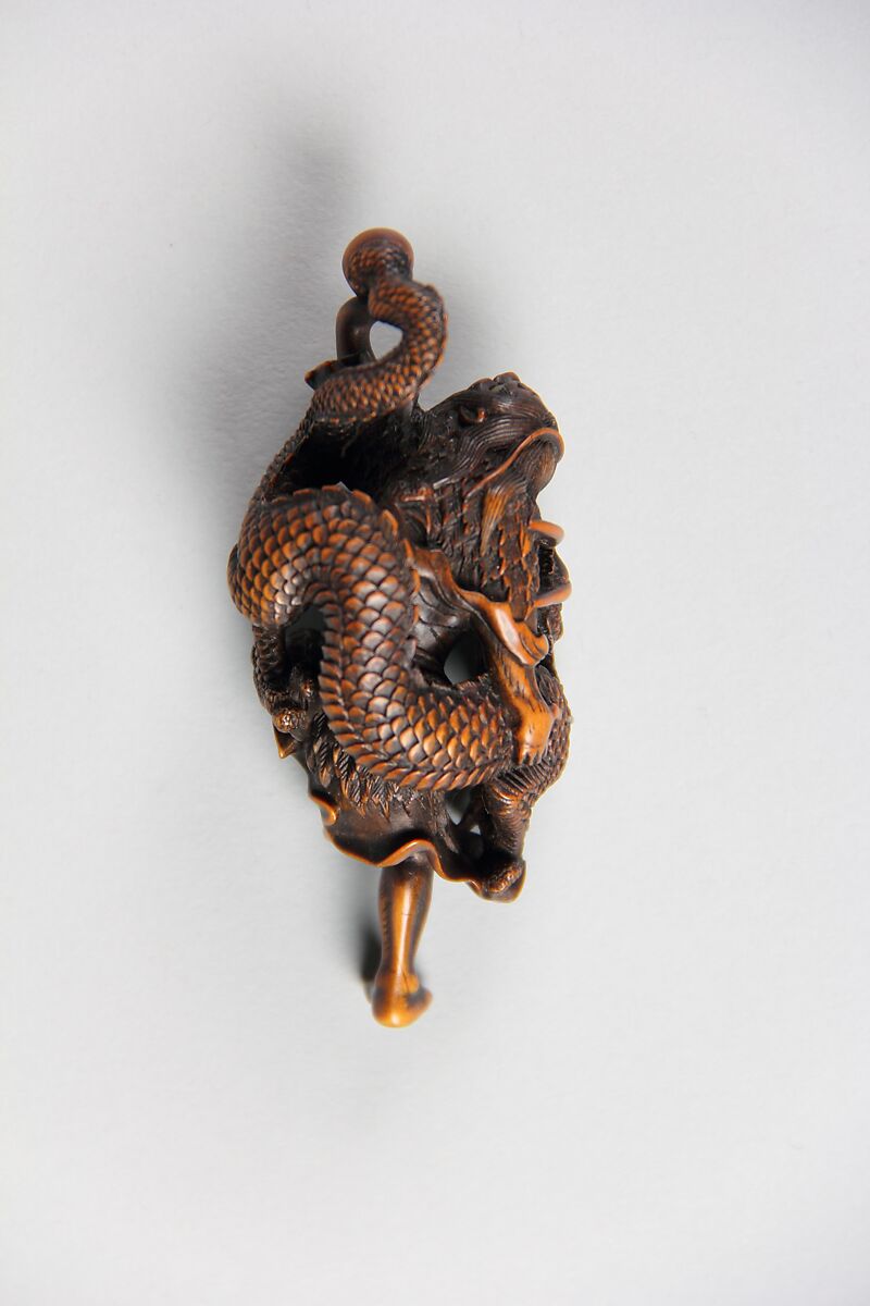 Netsuke of Dragon Coiled around the Body of a Man, Wood; inlaid glass eyes, Japan