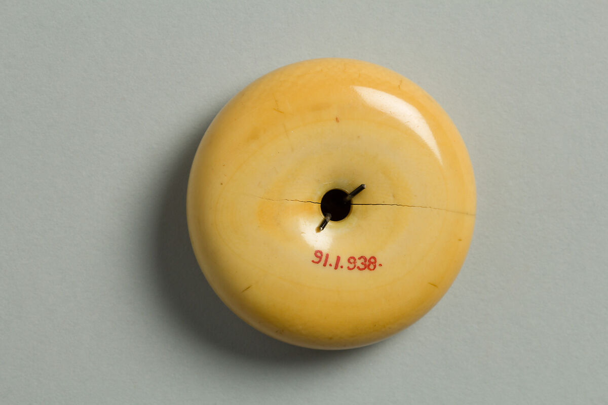 Netsuke Decorated with an Octopus in Lotus Leaves, Ivory with metal disc, Japan