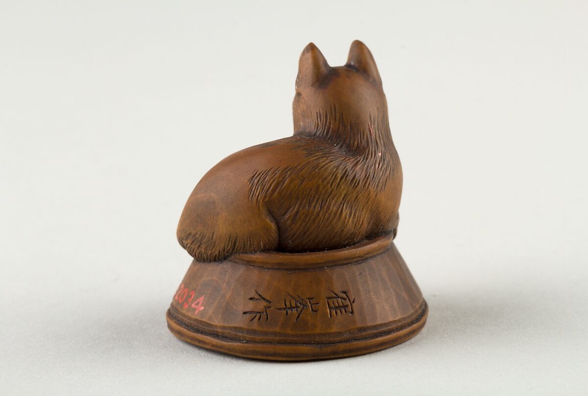 Netsuke of Cat Lying on a Bowl, underneath which is a Fish, Wood, Japan