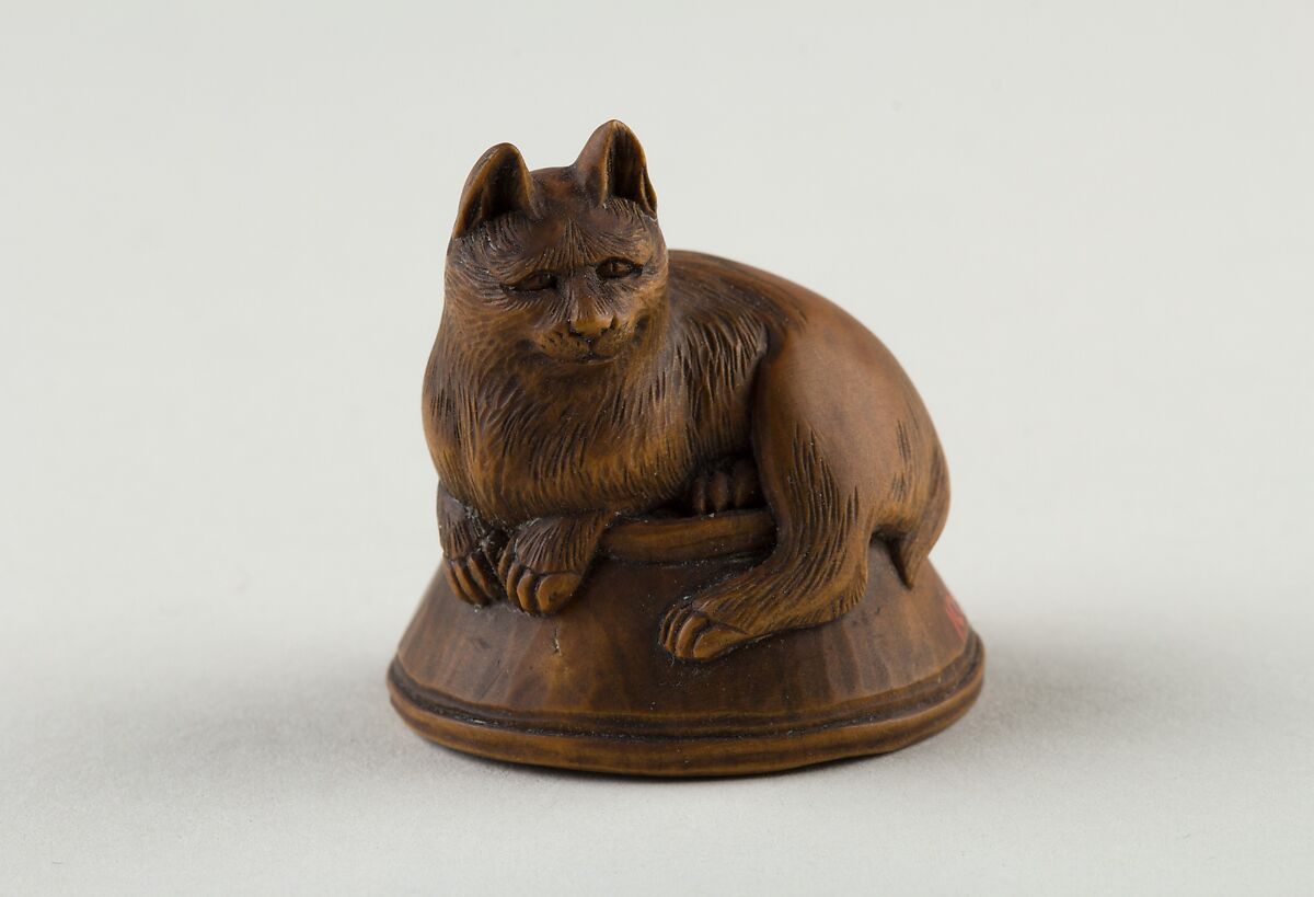 Netsuke of Cat Lying on a Bowl, underneath which is a Fish, Wood, Japan 