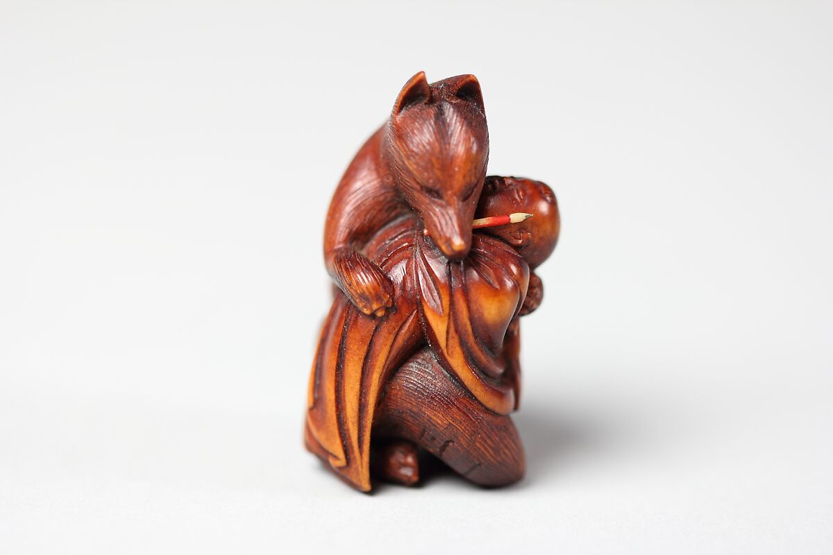 Netsuke of Fox Holding Baby and with Brush in Mouth from the Kabuki Play "Shinoda Zuma, Kuzonoha", Wood, Japan 