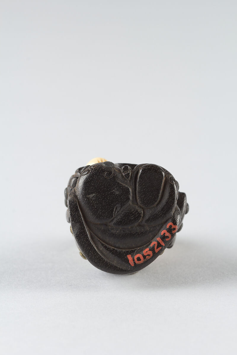 Netsuke of Boy with a Fan, Wood and ivory, Japan