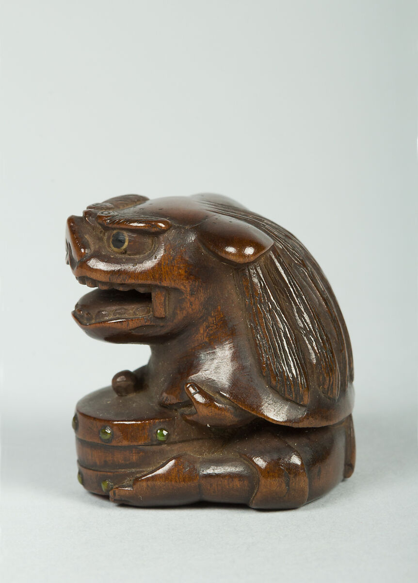 Netsuke of Man Wearing a Mask and Beating a Drum, Wood, Japan
