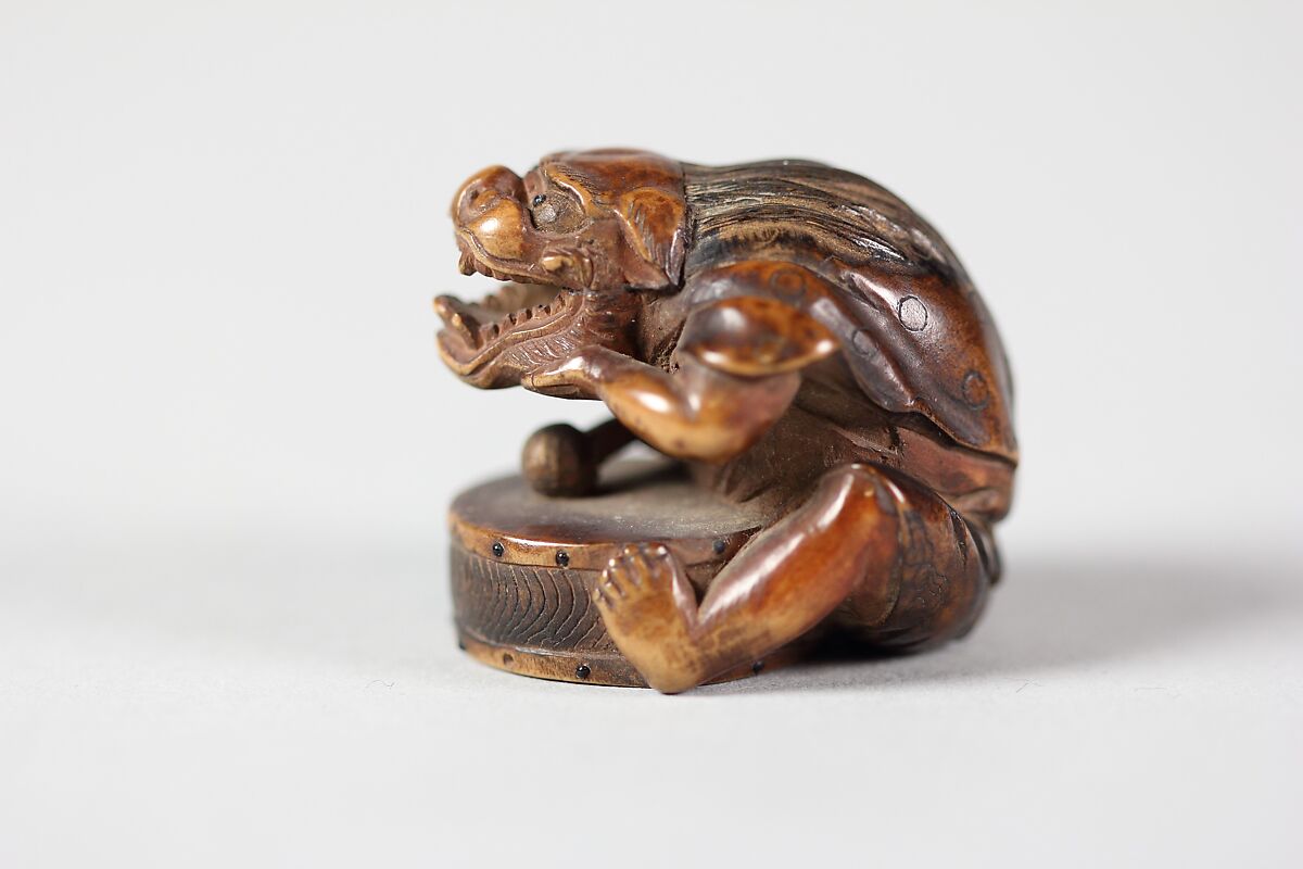 Netsuke of Masked Figure with a Drum, Wood, Japan