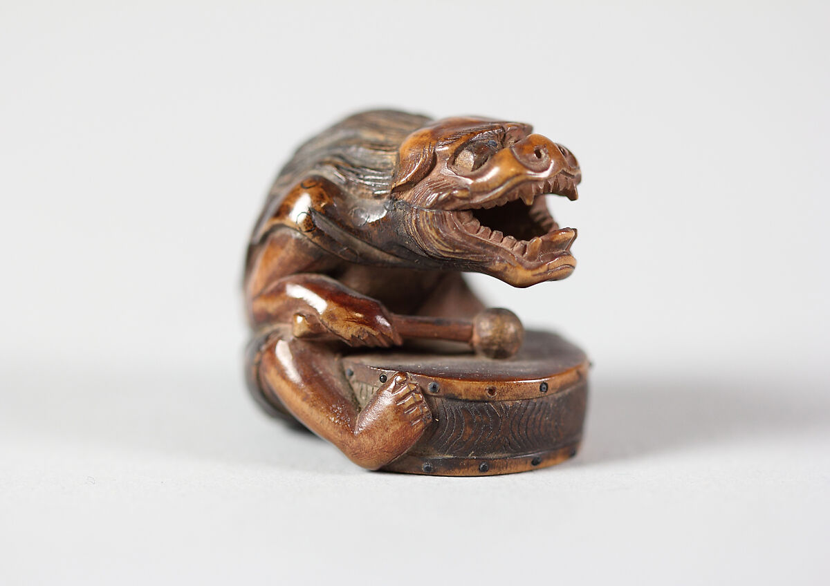 Netsuke of Masked Figure with a Drum, Wood, Japan 