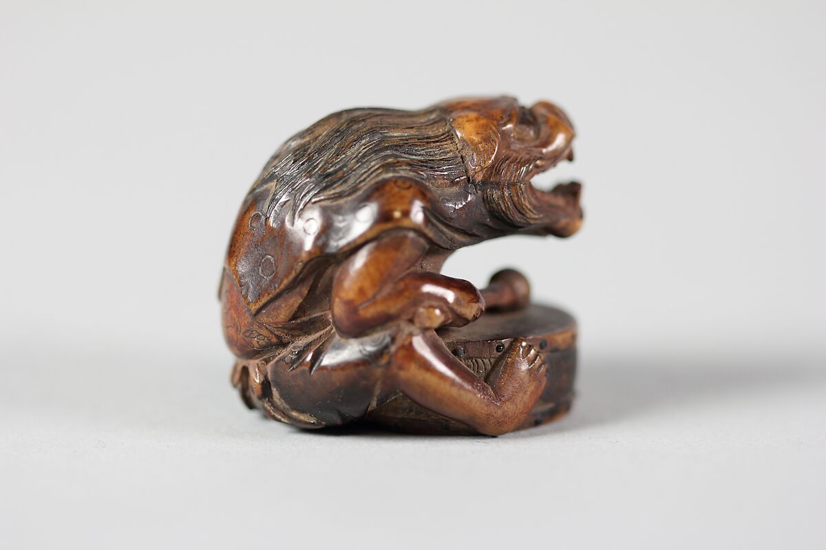 Netsuke of Masked Figure with a Drum, Wood, Japan