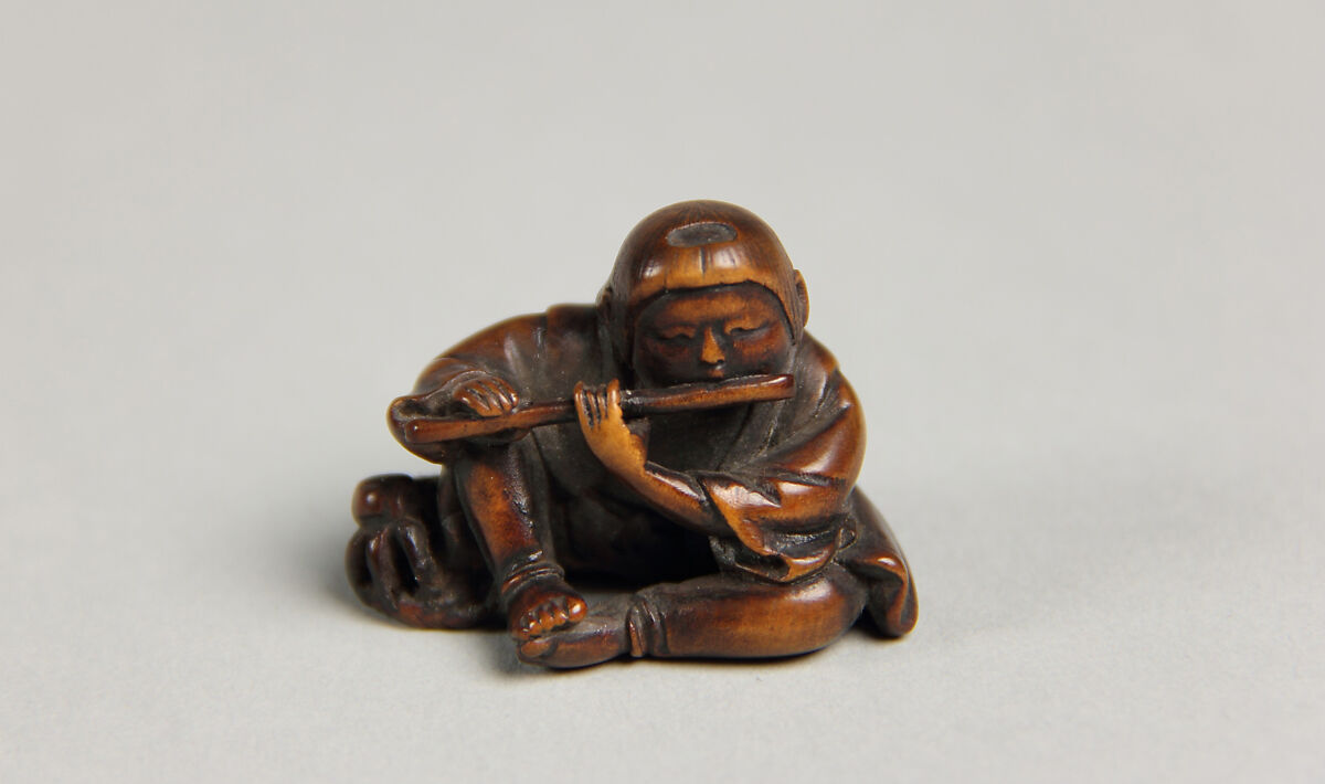 Netsuke of Boy Playing a Flute, Wood, Japan 