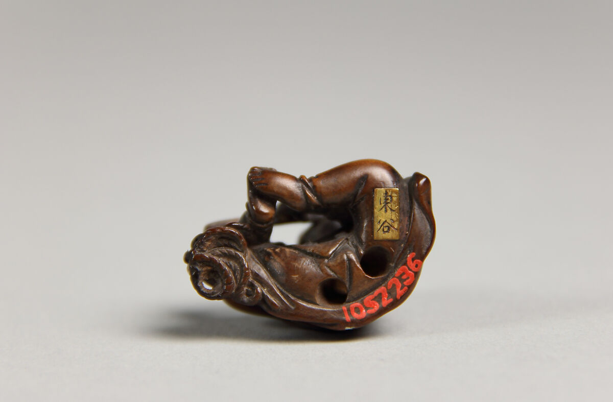 Netsuke of Boy Playing a Flute, Wood, Japan
