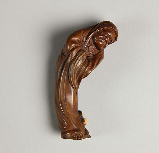 Netsuke of Daruma Tempted by Okami