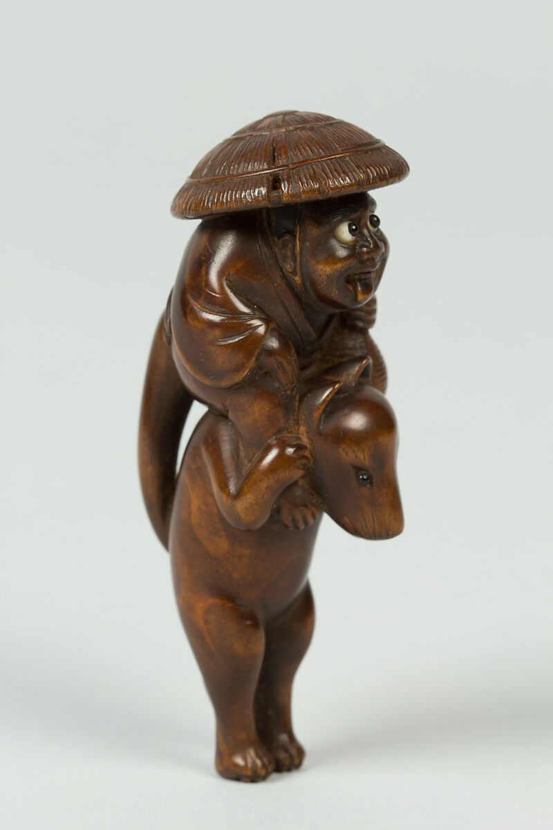 Netsuke of Boy Sitting on the Shoulders of an Animal, Wood; inlaid eyes, Japan