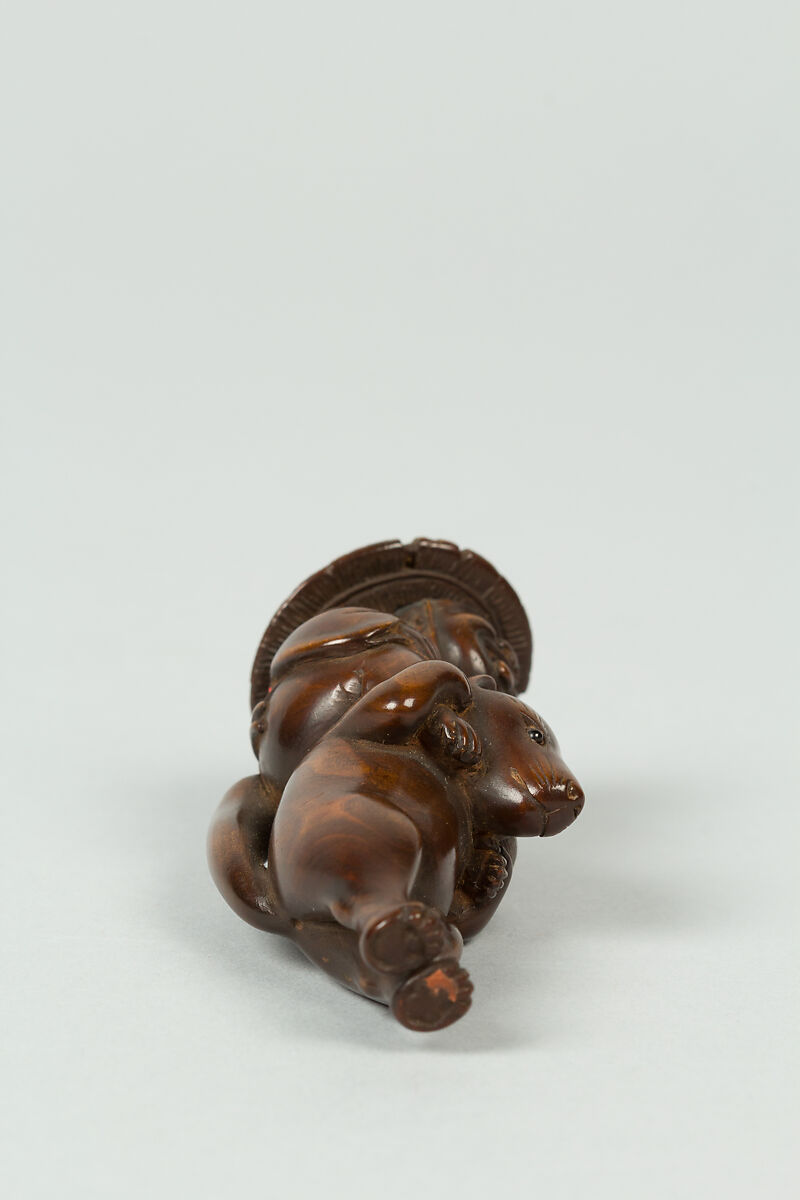 Netsuke of Boy Sitting on the Shoulders of an Animal, Wood; inlaid eyes, Japan