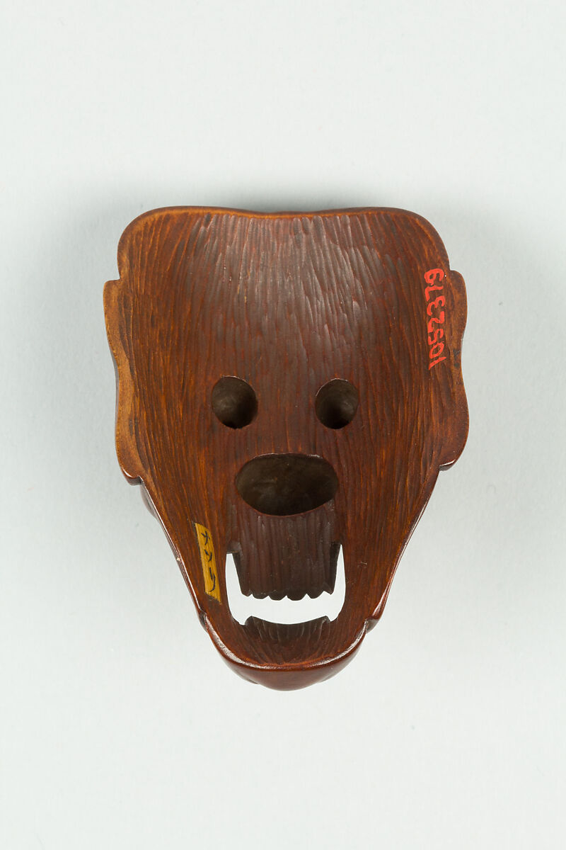 Netsuke of Mask, Wood; dark brown, inlaid eyes, Japan