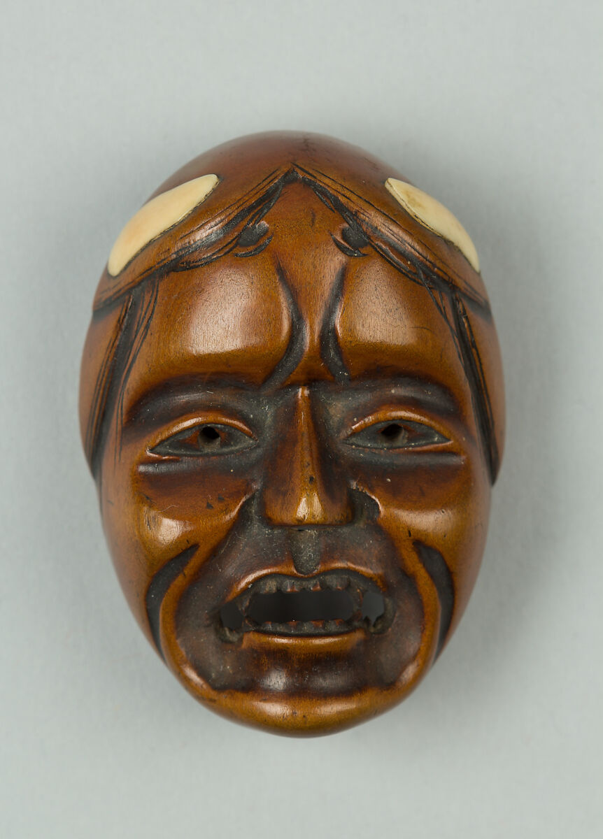 Netsuke of Woman's Face, Wood; ivory inlay to represent hair, Japan 
