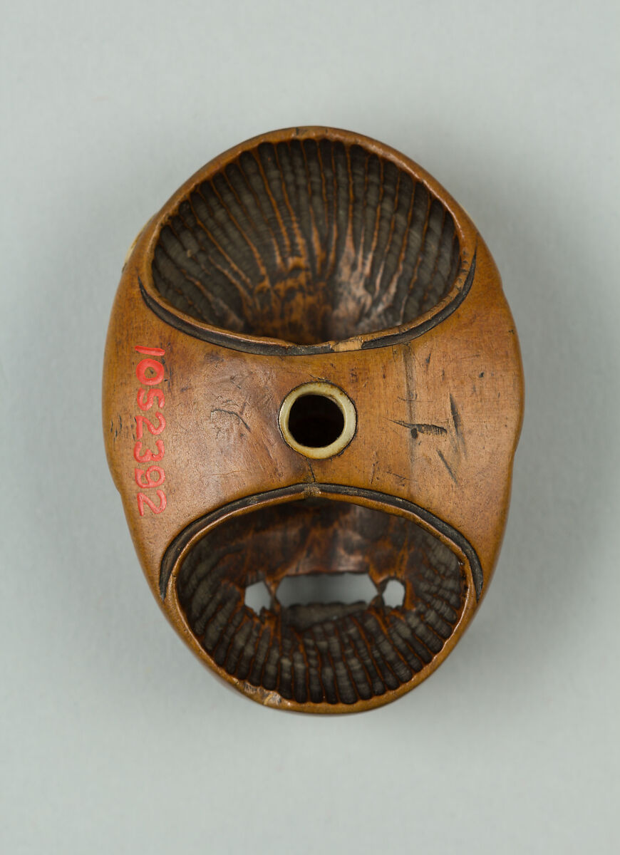 Netsuke of Woman's Face, Wood; ivory inlay to represent hair, Japan