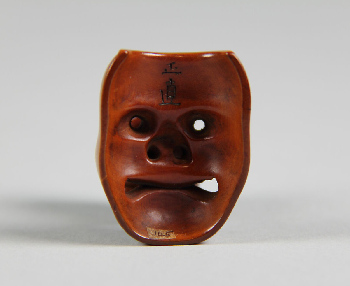 Netsuke of Mask; Uzume (Okame) and a Tengu mask, Wood, Japan