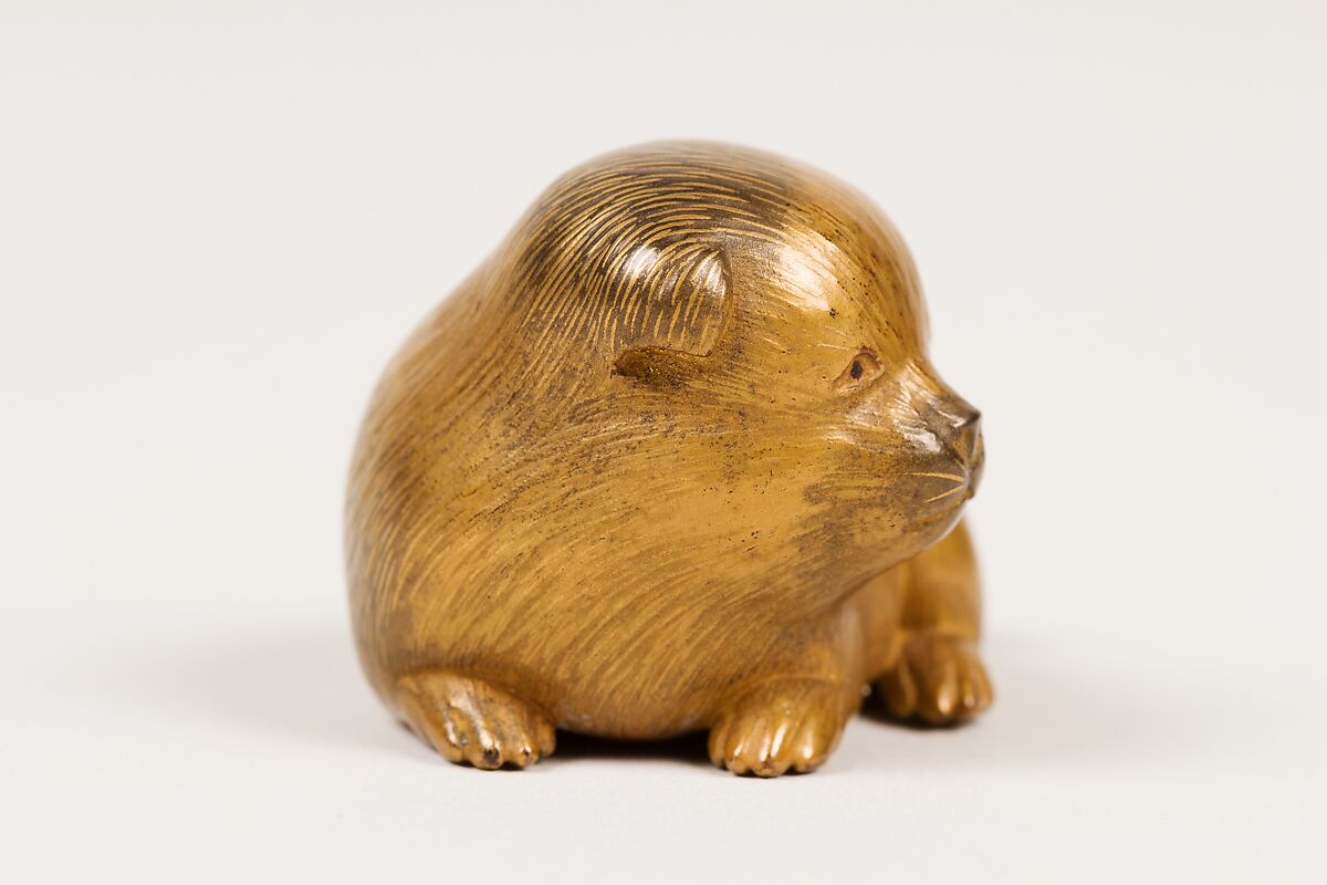Netsuke of Seated Puppy with Short Curled Tail, Norizane (Japanese), Wood, gold lacquer mottled with black; black lacquer eyes, Japan