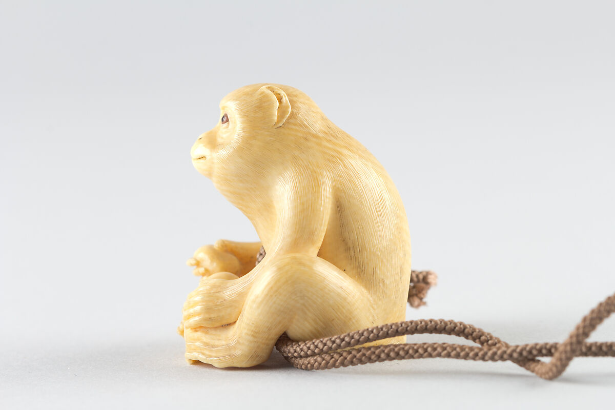 Netsuke of Seated Monkey with Persimmon, Ivory, Japan