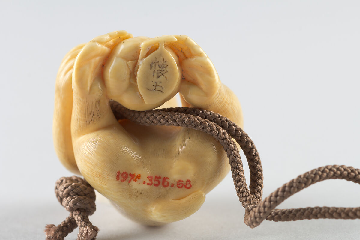 Netsuke of Seated Monkey with Persimmon, Ivory, Japan